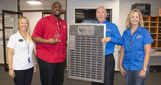 Eglin Federal Credit Union President/CEO Jerry Williams presents award to Quentin Youngblood