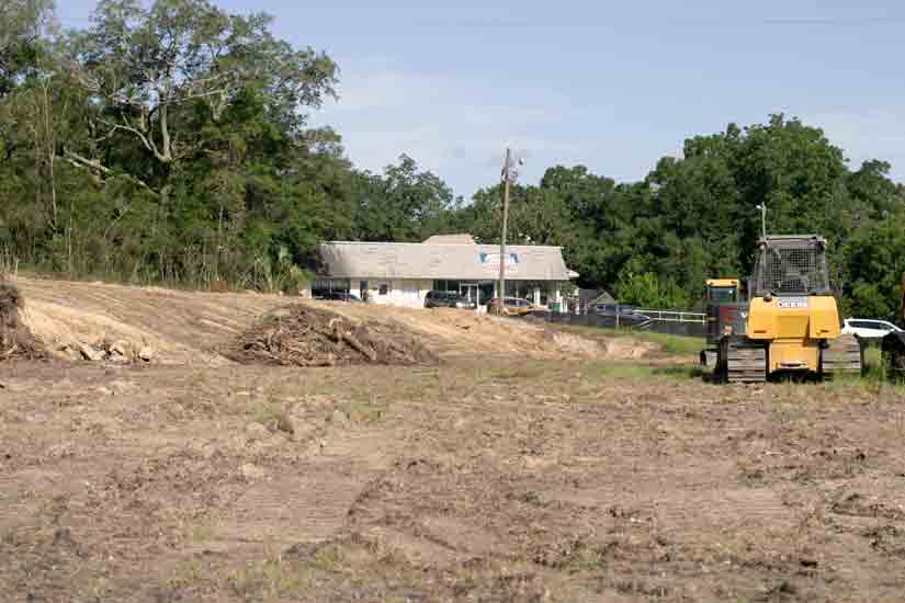 Site of land clearing for new hotel in Niceville, bulldozer