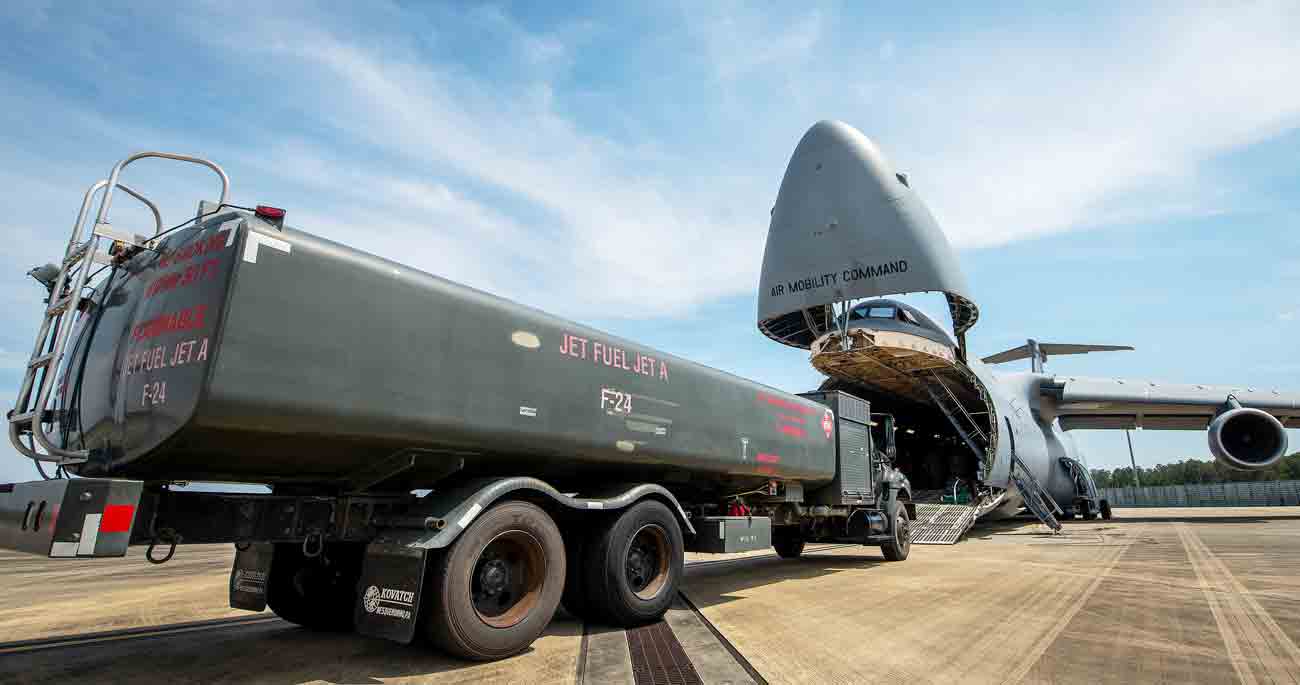 R-11 fuel truck rolls toward the mouth of a C-5 Super Galaxy to be loaded.