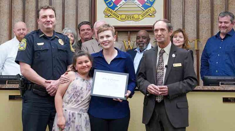 Crestview crossing guard Mackenzie Holliday receives life-saving award from Crestview Chief of Police Stephen McCosker and Mayor JB Whitten