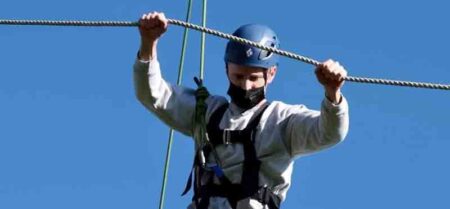 Master Sgt. Jesse Pickrell, 16th Electronic Warfare Squadron flight chief, navigates a high ropes obstacle course during the Coast Guard Chief Petty Officer Academy graduation