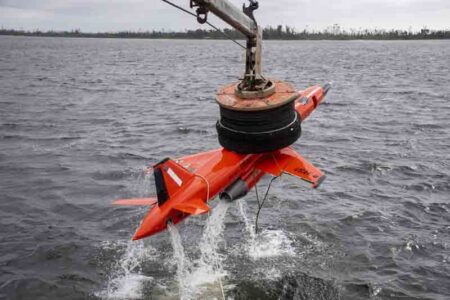 A BQM-167 subscale drone assigned to the 82nd Aerial Target Squadron, is lifted out of the water