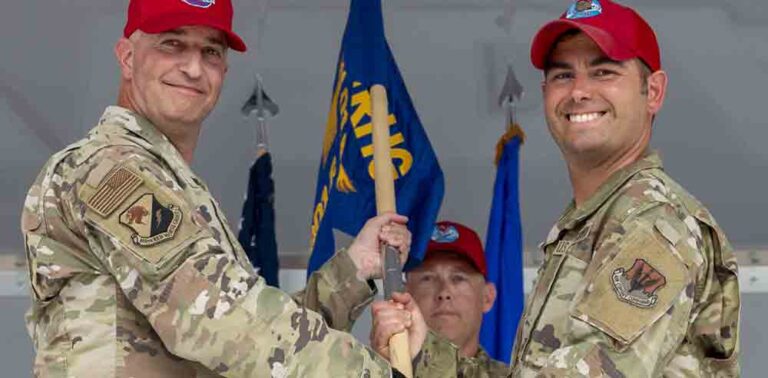 U.S. Air Force Col. Matthew Welling, 800th Rapid Engineer Deployable Heavy Operational Repair Squadron Engineers Group commander, left, presents Maj. Craig Poulin, with the guidon of the 801st RHTS at Tyndall Air Force Base,
