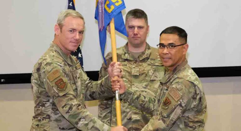 U.S. Air Force Col. Frederick Coleman, 505th Command and Control Wing commander hands the squadron’s guidon to Lt. Col. Alex Botardo, 505th Communications Squadron commander