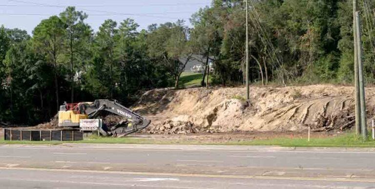 Site of land clearing for new hotel in Niceville, excavator