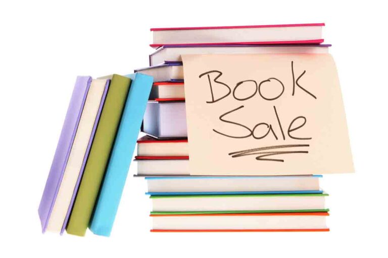 stack of books, hand-written Book Sale sign