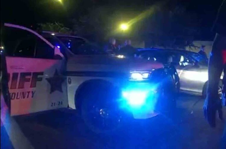 Okaloosa County Sheriff's Office deputies on the scene after stopping stolen vehicle. At night, blue lights, patrol vehicle in foreground.