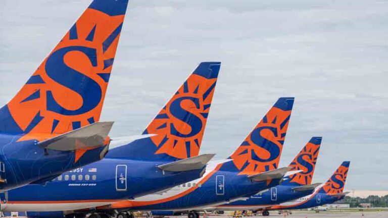Row of Sun County airliners showing logo on tails of six aircraft