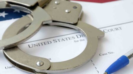 U.S. District Court. criminal complaint with handcuffs, ink pen