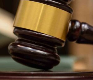 Outlaws biker pleads guilty in Fort Walton Beach explosion case judge gavel lies beside books on wooden background