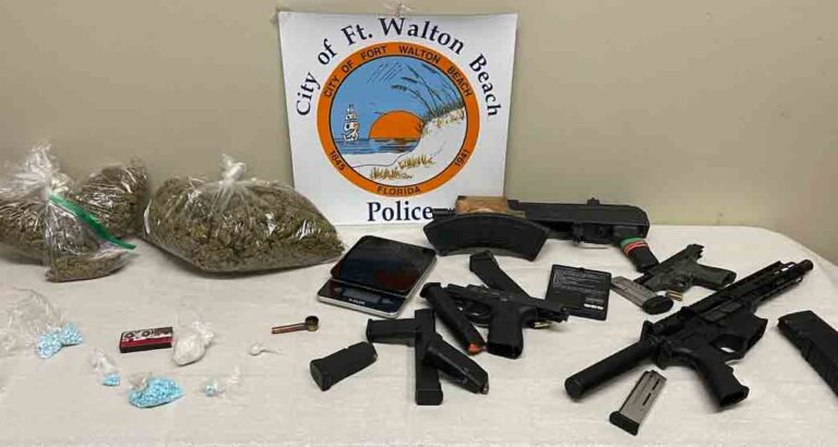 drugs, guns, ammunition, and scale on table at Fort Walton Beach Police Department