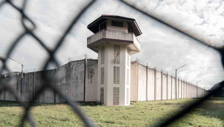 Prison seen through chainlink fence
