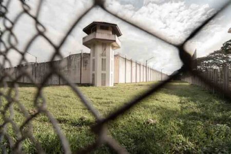 Prison seen through chainlink fence