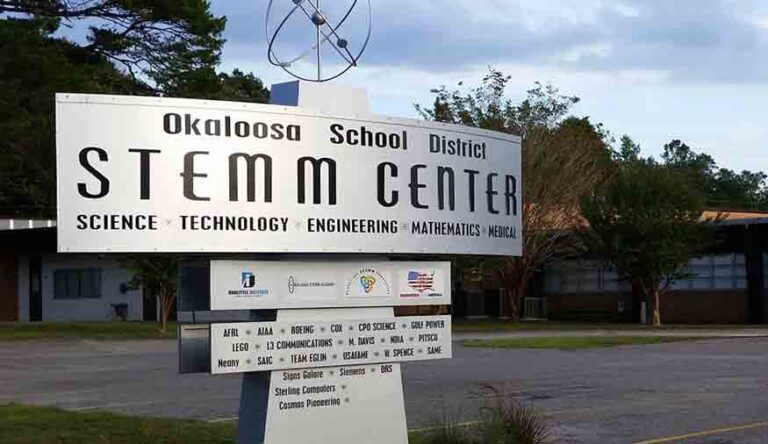 Okaloosa STEMM Academy sign with school in background