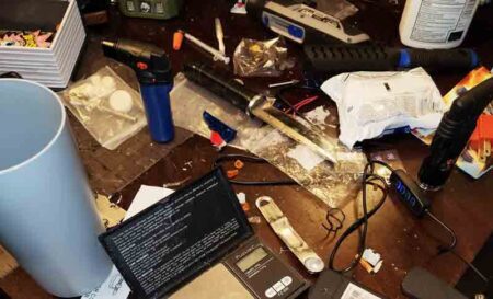 drugs, scales, syringes, drug paraphernalia on a table in a home searched by the Walton County Sheriff's Office in Freeport.