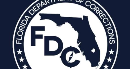 Florida Department of Corrections seal, cropped, on dark blue background.