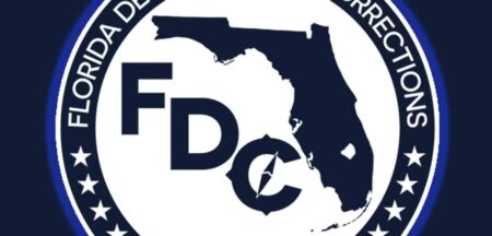 Florida Department of Corrections seal with a blue outer glow on dark blue background cropped.