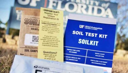UF/IFAS-branded Soil Test Kit on a lawn with UF/IFAS sign in the background.