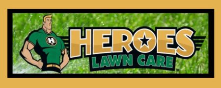 Heroes Lawn Care logo over lawn with sprinkler spraying