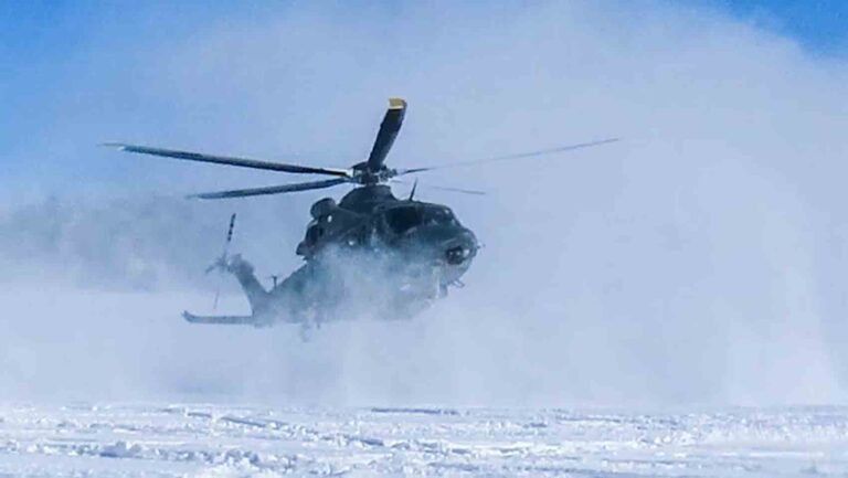 MH-139A Grey Wolf stirs up a cloud of snow as it touches down