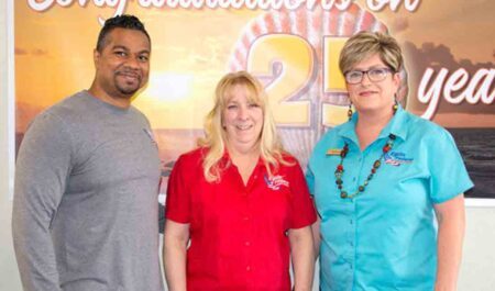 Eglin Federal Credit Union Mary Esther Branch Manager Ryan Fingall, Member Service Supervisor Amanda Nelson, Mary Esther Head Teller Kim Stovall stand together.