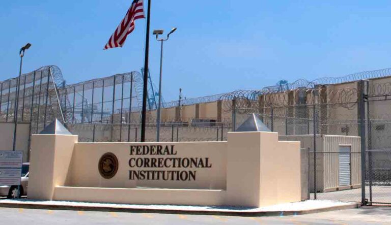 Federal Correctional Institution prison. Prison guard tower, fence and razor wire