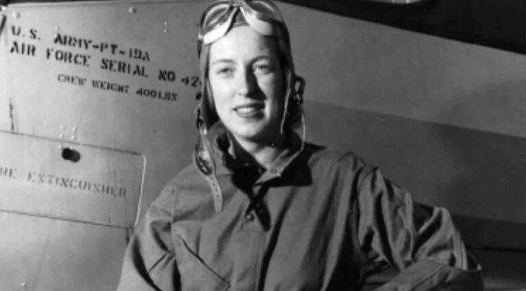 Jackie Cochran standing next to aircraft