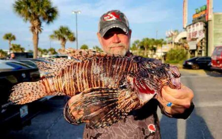 man with large lionfish