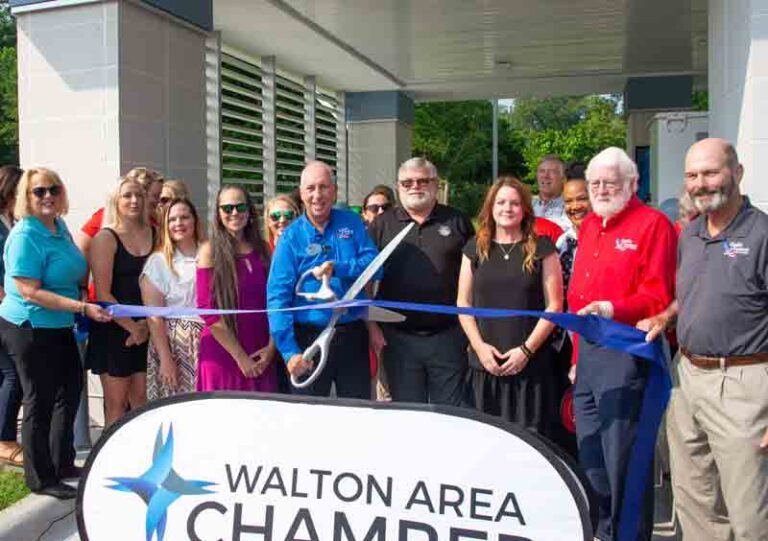 group cutting ribbon in front of ATM/video teller drive-thru