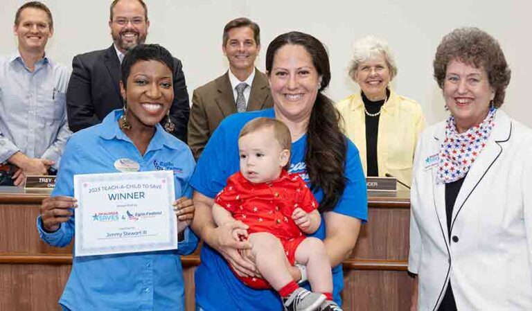 eight people pose with award certificate