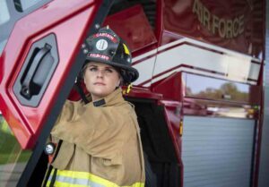 female firefighter wearing captain's helmet