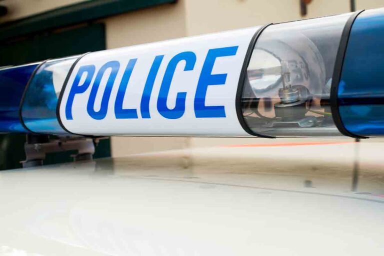 blue lights on police car with the word "POLICE" in blue