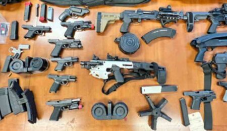 guns, ammunition, clips, machine gun on table