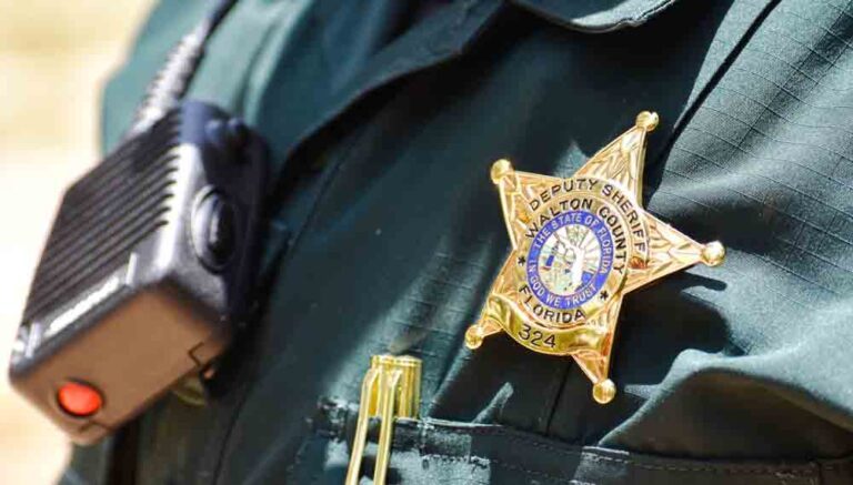 Badge, two-way radio, on deputy
