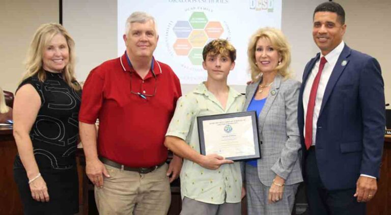 Award-winner with parents, school officials