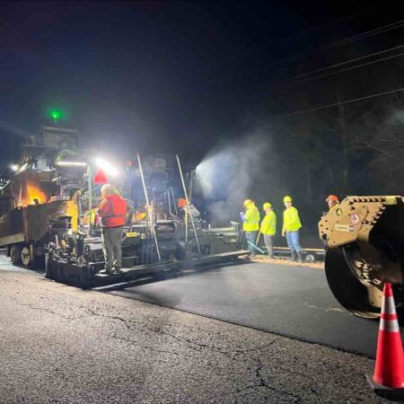 Nighttime paving to close I-10 rest area Monday and Tuesday workers and heavy equipment resurfacing a road at night