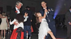 two father-daughter couples dancing