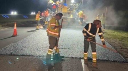 nighttime paving crews placing the final, friction layer of asphalt on the U.S. 98 travel lanes in Walton County, Florida