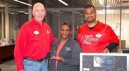 Eglin Federal Credit Union President/CEO Jerry Williams, Mary Esther Branch Manager Ryan Fingall and Mary Esther Teller Gwen Woullard with her 5-Star Performer Award.