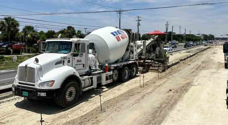 Roadwork crew placing concrete curb as part of the U.S. 98 widening project between Mandy Lane and Richard Jackson Boulevard in Panama City Beach, Bay County, Florida.