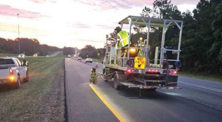 Nighttime pavement striping underway for a newly paved section of roadway in Okaloosa County, Florida.