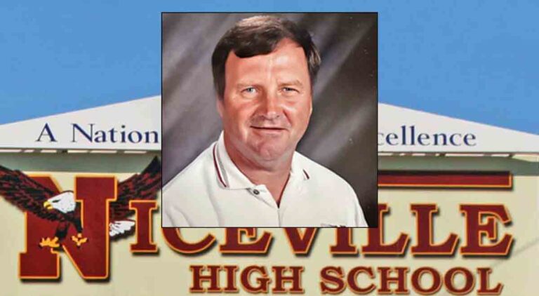 Jerry Colquitt, former head baseball coach of Niceville High School, head and shoulders portrait, with Niceville High School sign in the background