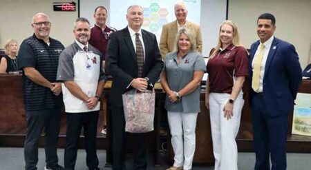 Craig Miller with family members, Okaloosa County school officials