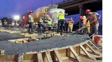 Crews constructing a seal slab for the Brooks Bridge Replacement Project after dark in Okaloosa County