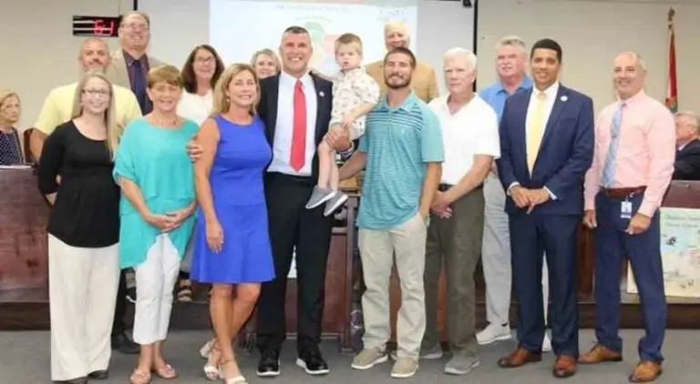 Grant Meyer standing with family, friends and school officials at a school board meeting in Niceville, Florida where he was named Assistant Superintendent of Operations .