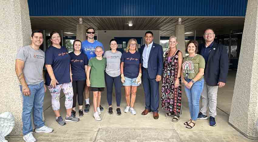 Okaloosa County Superintendent of School Marcus Chambers stands with a group of school volunteers