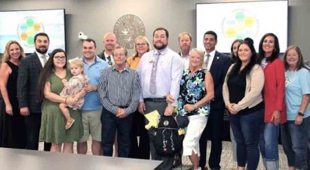 Robert Maddens with family members and school officials after being named Assistant Principal of Ruckel Middle School.