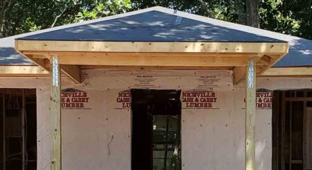 A close-up view of a newly constructed home in Niceville under the Community Development Block Grant (CDBG) program, highlighting the front porch structure and exterior progress.