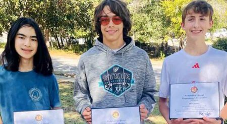 Three Niceville High School students, Luke Chavers, Chase Robbins, and Sebastian Shinnick, proudly holding certificates of recognition for their first-place achievement in the Congressional App Challenge.