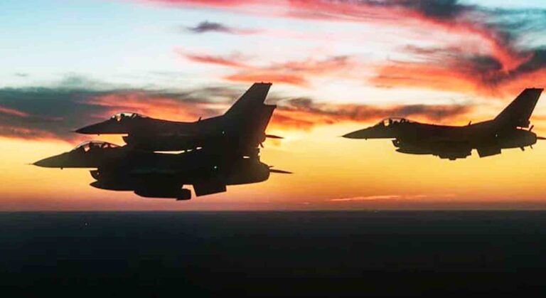 Three fighter jets in flight against a vibrant sunset sky, silhouetted against the evening clouds.